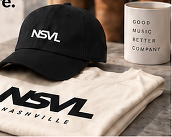 Illustration: a charcoal NSVL cap on a folded paper-white NSVL tee beside a coffee mug.